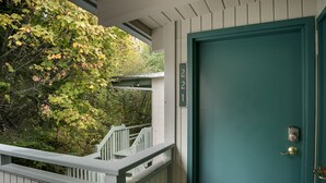 A teal door with a brass doorknob and a mailbox with the number 221. - Flathead Lake Waterfront Studio! (Bigfork)