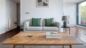 Una sala de estar moderna con un sofá, una mesa de centro y una lámpara.