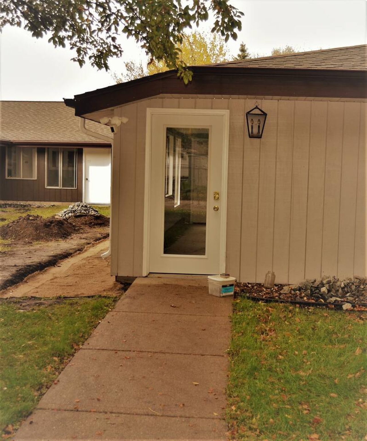 A small, single-story building with a front door and a small porch area.