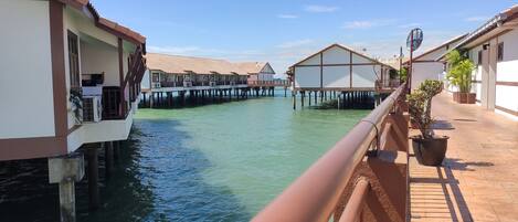 A canal with overwater bungalows connected by walkways.