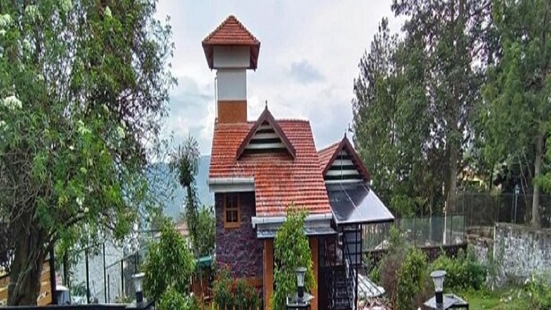 A house with a red roof, a chimney, and a small tower-like structure. - Kasal's Stay (Kodaikanal)