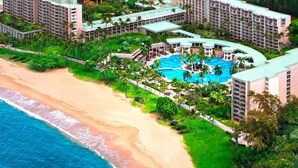 A resort with multiple high-rise buildings, a central pool area, and a beach. - Marriott Kauai Lagoons - Kalanipu'u - Luxurious 2-Bedoom - Beachfront resort - Family Friendly (Lihue)