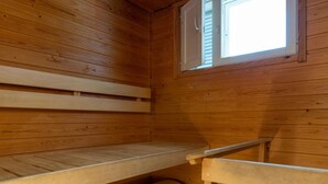 Ein Holzhüttenraum mit Stockbetten und einem Fenster.