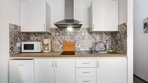 A compact kitchen with white cabinets, a microwave, a coffee maker, and a sink. - Vacation Home "Estudio Sagrario" with Shared Pool (Arona)