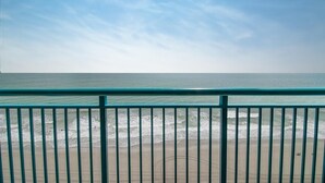 A beach view with a railing in the foreground. - Oceanfront 3 BR Condo Amazing Views 11th floor! (Myrtle Beach)