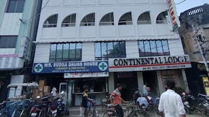 A multi-story building with a pharmacy and a lodge on the ground floor. - continental lodge  (Malda)