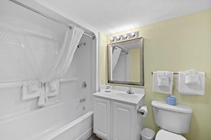 A bathroom with a shower, a sink, a toilet, and a mirror. - Escape to Paradise Resort OV King Room 9th Floor (Myrtle Beach)