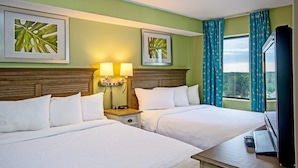 A hotel room with two beds, a TV, and a window with curtains. - Brilliant Oceanfront 12th Floor 3BR Condo (Myrtle Beach)