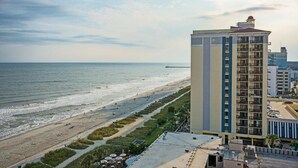 A beachfront hotel with a view of the ocean and a pier in the distance. - Peaceful Oceanfront 15th Floor 3 Bedroom Condo (Myrtle Beach)