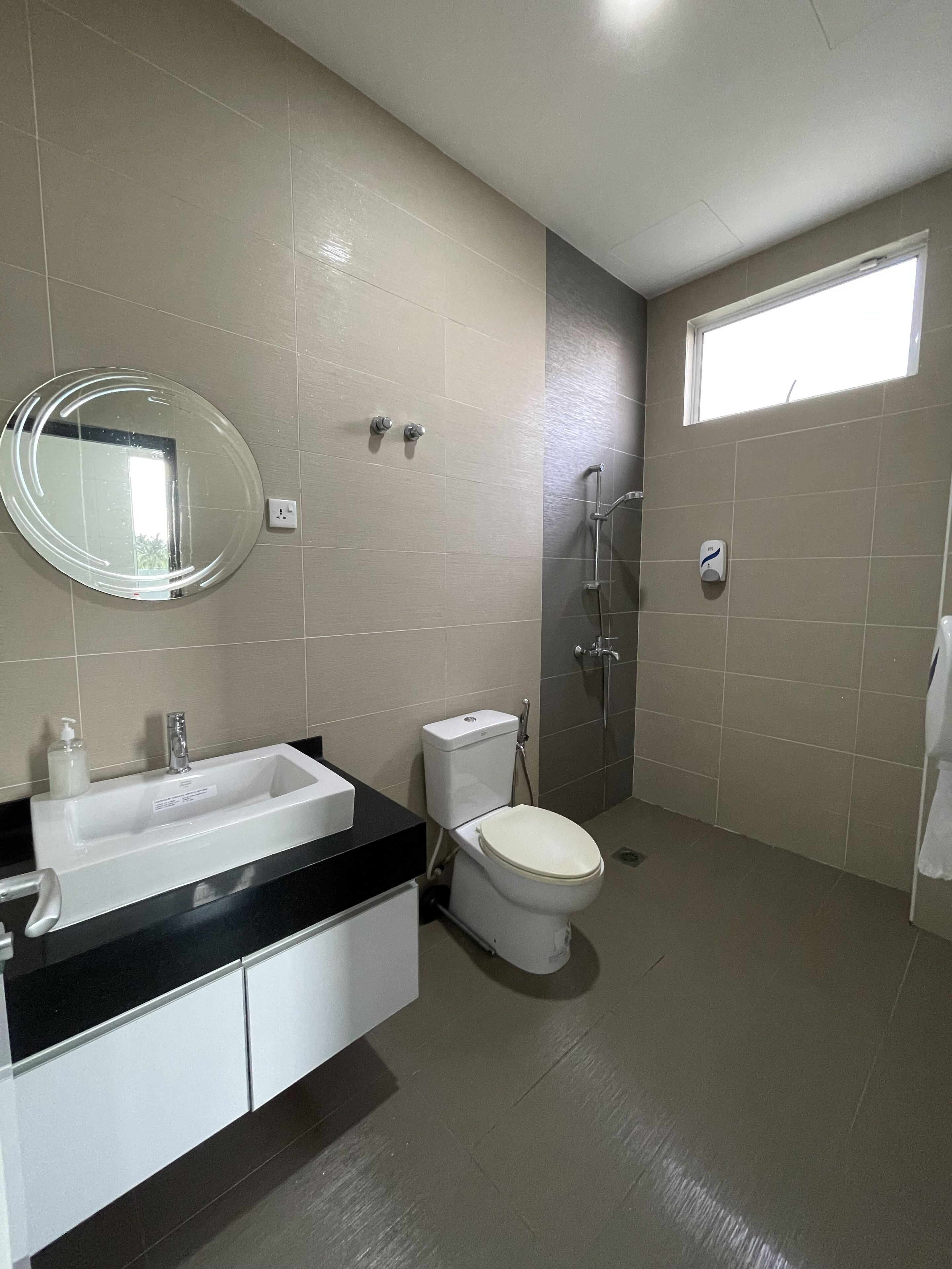 A bathroom with a sink, toilet, and shower.
