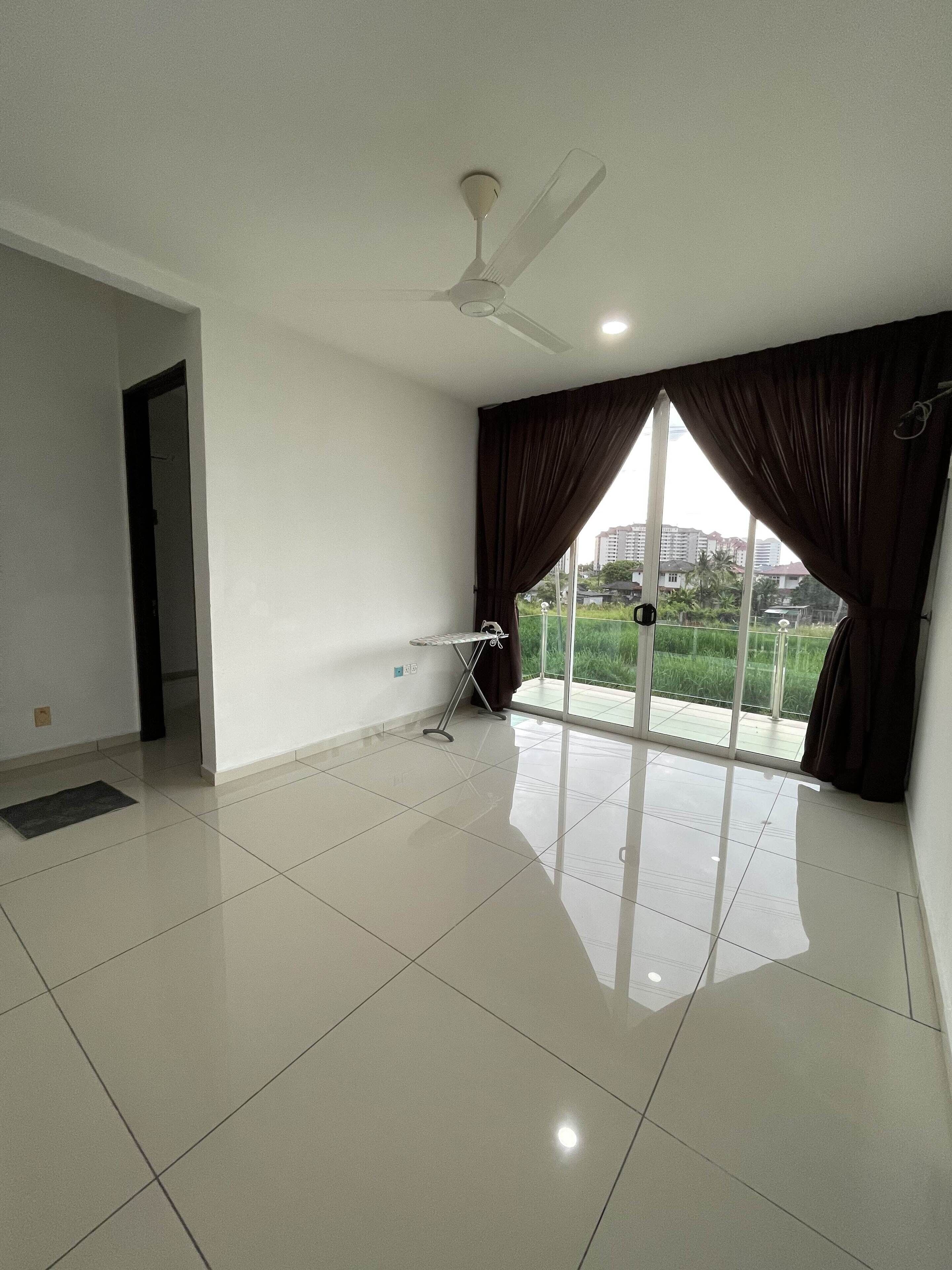 A spacious room with a large window, a ceiling fan, and a small table.