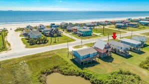 An aerial view of a coastal residential area with houses, a beach, and a road. - Ocean Pearl - Ultimate Beach & Boat Watch Escape! (Surfside Beach)