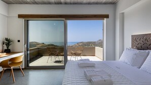 A bedroom with a bed, a desk, a chair, and a view of the sea. - Seaview villa w/private pool, 4km to Plakias beach (Mariou)