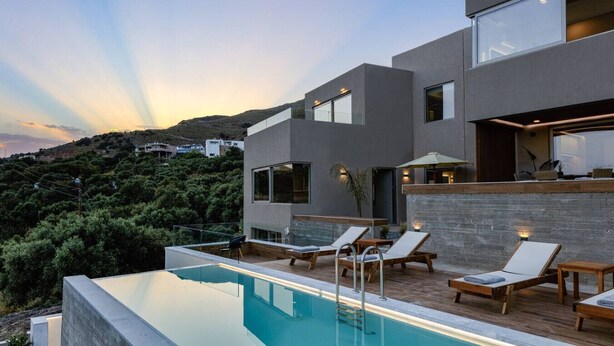 A modern house with a swimming pool, lounge chairs, and a view of the surrounding landscape. - Seaview villa w/private pool, 4km to Plakias beach (Mariou)