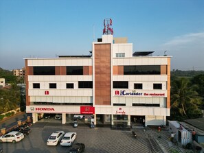 A multi-story building with a Honda dealership, a restaurant named 'Coriander the restaurant', and a Landmark Honda store.