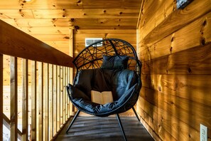 A wooden interior with a black chair and an open book. - Fire Pit*2 Hot Tubs*Basketball*Game Room*Mtn Views (Sevierville)