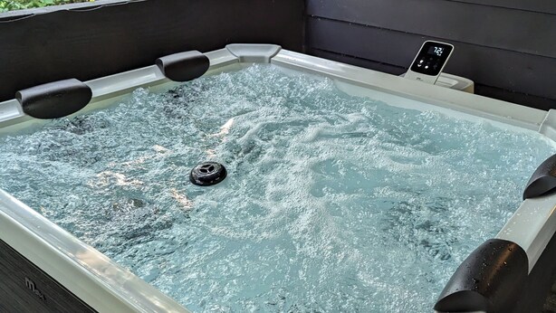 A hot tub with a control panel and a view of greenery outside. - 2BR Sleeps 8 near Penn State, Stadium & Downtown with Hot Tub (State College)