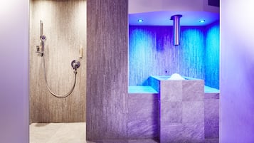 A modern bathroom with a shower, a bathtub, and a vanity.