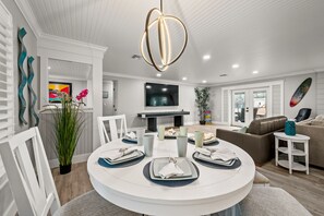 Enjoy meals in this inviting dining area with a round table for four, flat-screen TV, and comfortable seating.