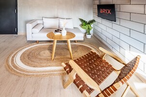 Deluxe Quadruple Room | Living area | Flat-screen TV