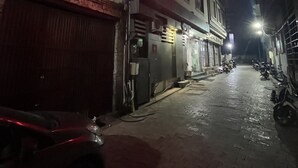 A Tushar Hotel sign, a brick building, and parked motorcycles. - Hotel Tushar Residency (Mathura)