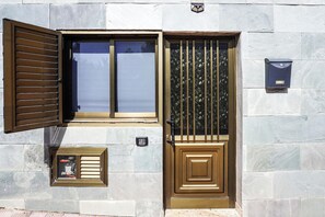 Stylish entrance with a large metal door and decorative glass window.