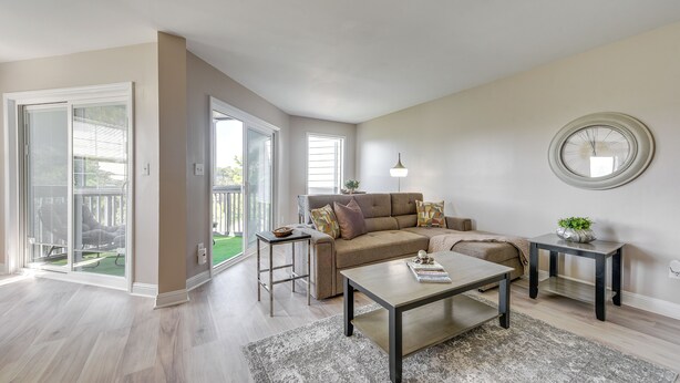 A spacious living room with a sofa, coffee table, and side tables. - North Myrtle Beach Oasis w/ Community Pool! (North Myrtle Beach)