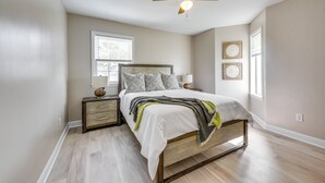 A bedroom with a bed, nightstands, a ceiling fan, and a window. - North Myrtle Beach Oasis w/ Community Pool! (North Myrtle Beach)
