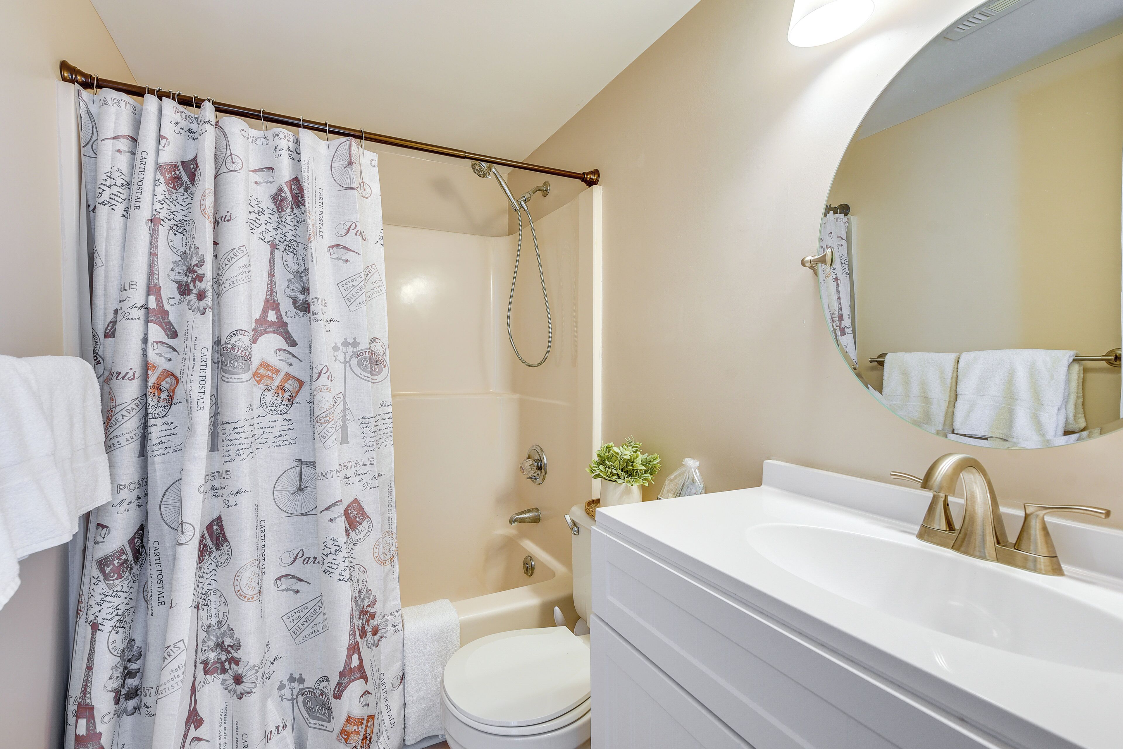 A bathroom with a shower, toilet, and sink.
