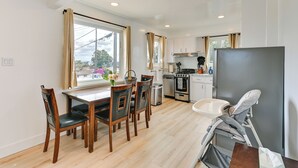 A modern kitchen with a dining area, large windows, and a baby changing station. - Sunny San Diego Home w/ Private Yard & Grill! (San Diego)