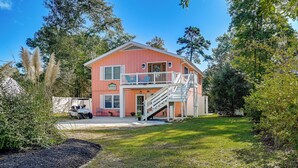 A two-story house with a balcony, a staircase, and a driveway. - Pawleys Island Retreat (Pawleys Island)