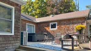 A wooden deck with outdoor furniture, a hot tub, and a small patio area. - Beautiful 3 BR Cedar Ranch Home with Awesome Master and Cooks Kitchen  (Colchester)