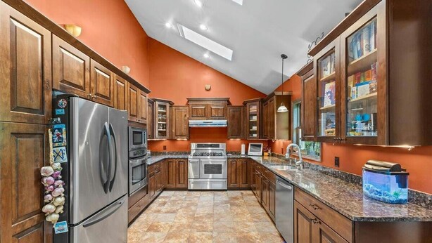 A kitchen with wooden cabinets, stainless steel appliances, and a granite countertop. - Beautiful 3 BR Cedar Ranch Home with Awesome Master and Cooks Kitchen  (Colchester)