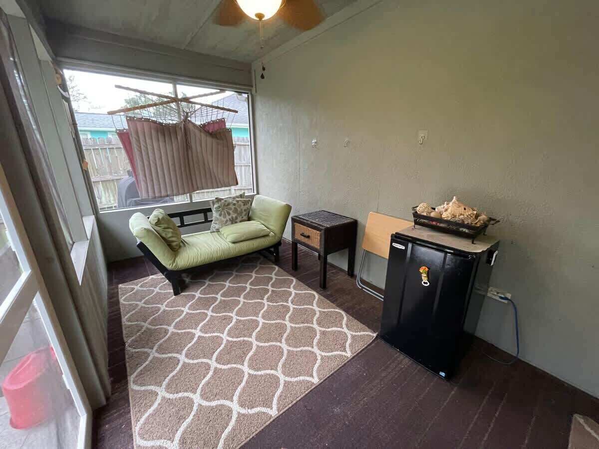 A compact living space with a sofa, a small table, and a cabinet.