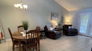 A spacious living room with a dining area, a fireplace, and a large window. - Comfortable Coastal 2 BDRM home - 5 mins to downto (saint marys)