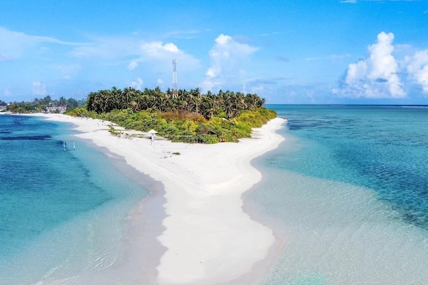 On the beach, white sand, sun-loungers, beach umbrellas