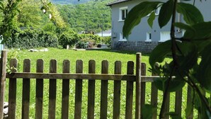 A house with a stone foundation, a grey exterior, and a white window trim. - Maison à la Montagne Avec la vue sur le Montcalm Avec son Jardin Clôturé (Auzat)