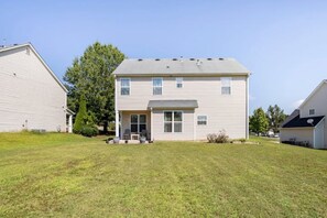 A two-story residential building with a front porch, a covered entryway, and a small front yard. - Sleeps 8: King sized bed - Home away from home, yet close to everything! (Douglasville)