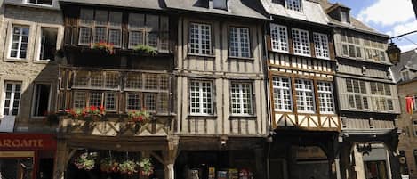 A traditional half-timbered building with a ground-floor shop and upper residential or commercial spaces.