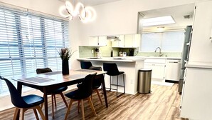 A modern kitchen with a dining area. - Tall Palms Oasis (McAllen)