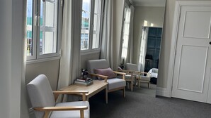 A room with a large window, a ceiling light, and a door.