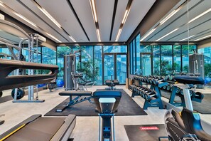 A modern gym with cardio equipment, weight machines, and dumbbells. - A505- 2 Bdr Condo With Forest View, Ao Nang Beach (Krabi)