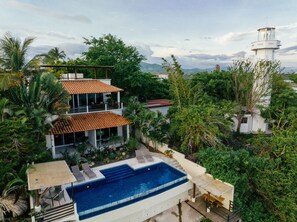 Enjoy a serene environment with a view of the surrounding hills and mountains from this two-story property.