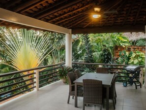 Enjoy al fresco dining amidst lush tropical surroundings and a grill for outdoor cooking.