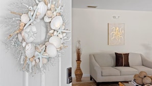 A living room with a neutral color scheme, a sofa, a decorative wall piece, and a vase with dried plants. - Coastal Chic House in Cocoa Beach w/Private Yard - Walk to Beach, Pier & Ron-Jon (Cocoa Beach)