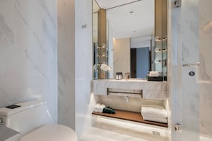 A modern bathroom with a marble floor, a large mirror, a vanity with a sink, and a glass shower enclosure. - Grand Madison Hangzhou Yuedonghu (Hangzhou)