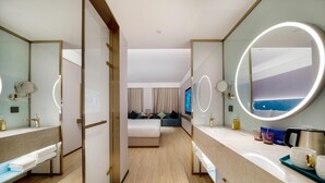 A hotel room with a bed, a sitting area, a bathroom with a mirror, and a TV. - Manxin Hotel Hefei Jingkai District Pearl Plaza (Hefei)