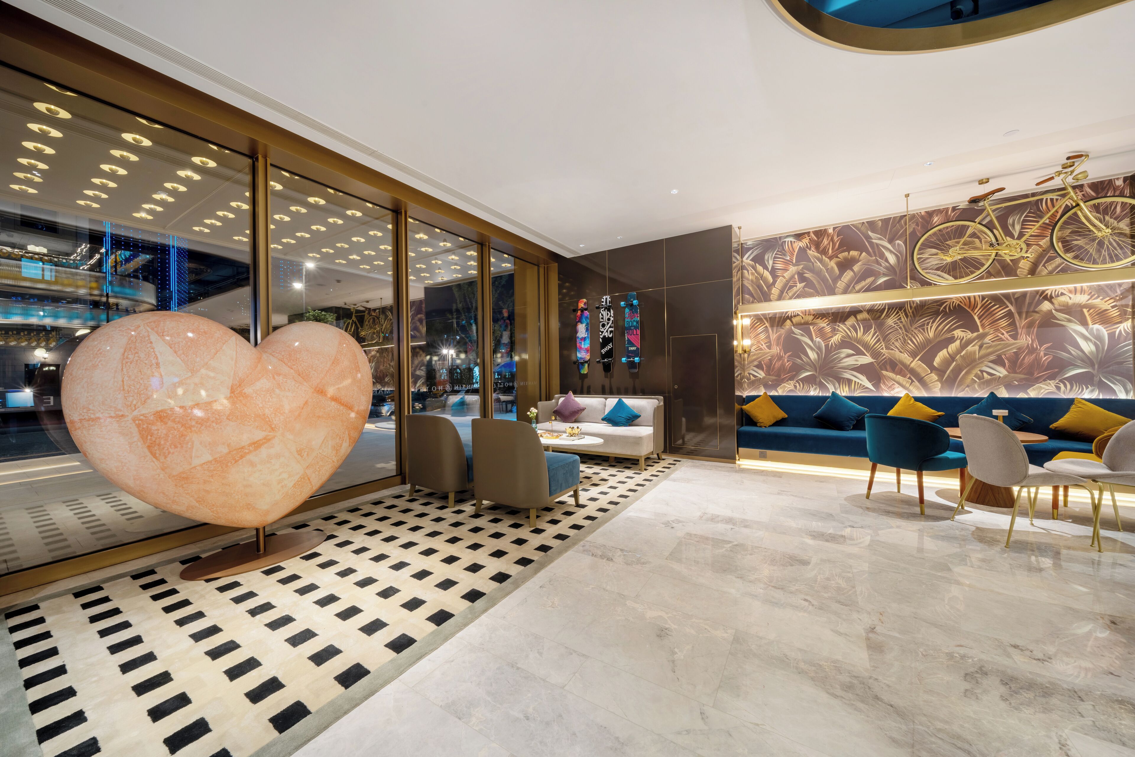 A modern interior with a large heart-shaped sculpture, a sofa set, and a patterned floor.