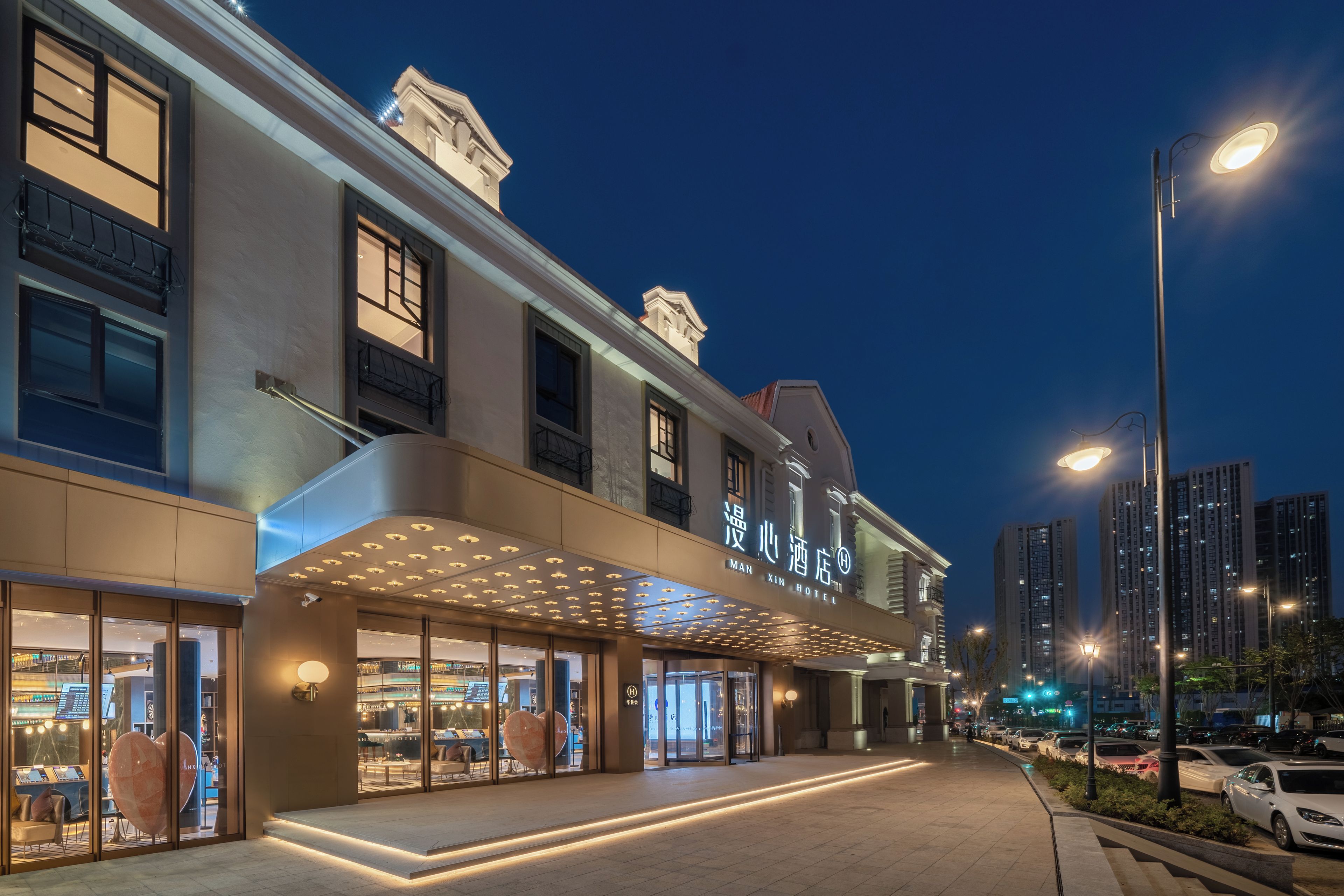 A hotel with a modern facade, large glass windows, and a prominent entrance with a canopy.