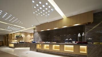 A modern reception area with a marble counter, wooden paneling, and recessed lighting.
